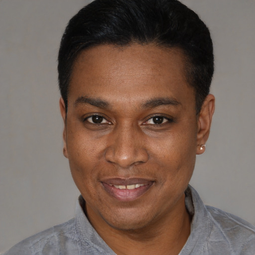 Joyful black adult male with short  black hair and brown eyes