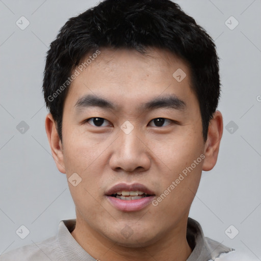 Joyful asian young-adult male with short  black hair and brown eyes