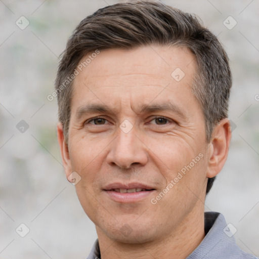 Joyful white adult male with short  brown hair and brown eyes