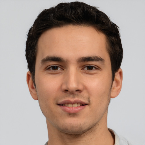 Joyful white young-adult male with short  black hair and brown eyes