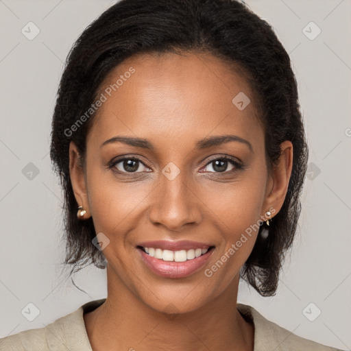 Joyful black young-adult female with long  brown hair and brown eyes