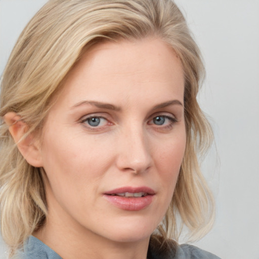 Joyful white young-adult female with medium  blond hair and blue eyes