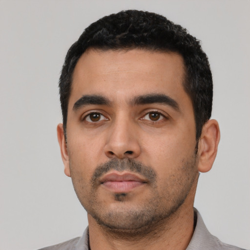 Neutral latino young-adult male with short  black hair and brown eyes
