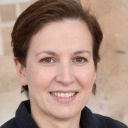 Joyful white adult female with medium  brown hair and grey eyes