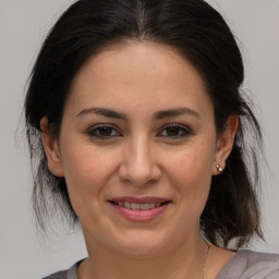 Joyful white adult female with medium  brown hair and brown eyes