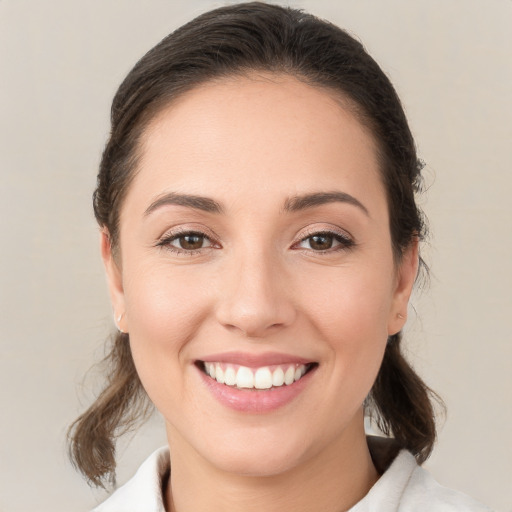 Joyful white young-adult female with medium  brown hair and brown eyes