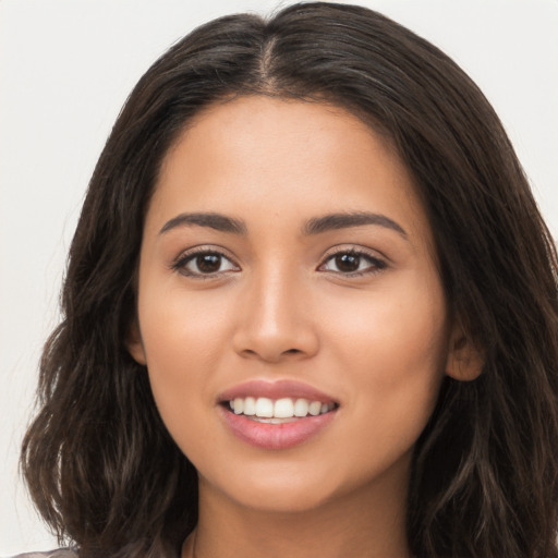 Joyful white young-adult female with long  brown hair and brown eyes