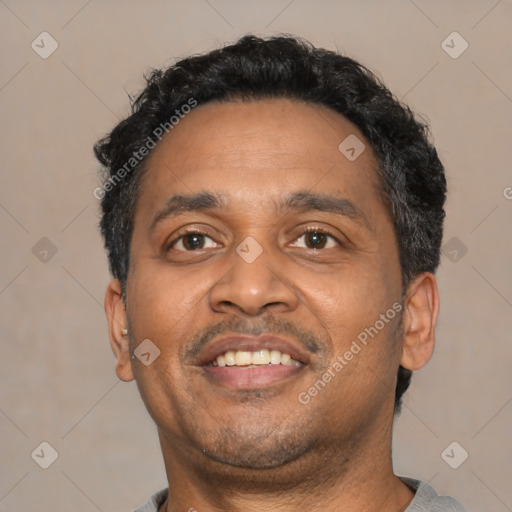 Joyful latino adult male with short  black hair and brown eyes