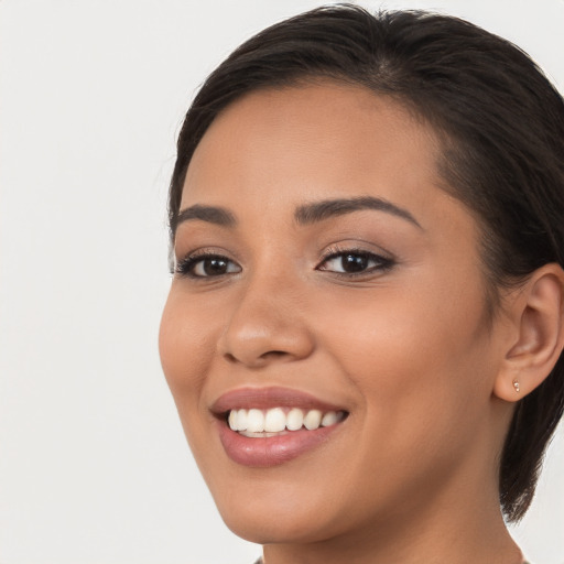 Joyful latino young-adult female with long  brown hair and brown eyes