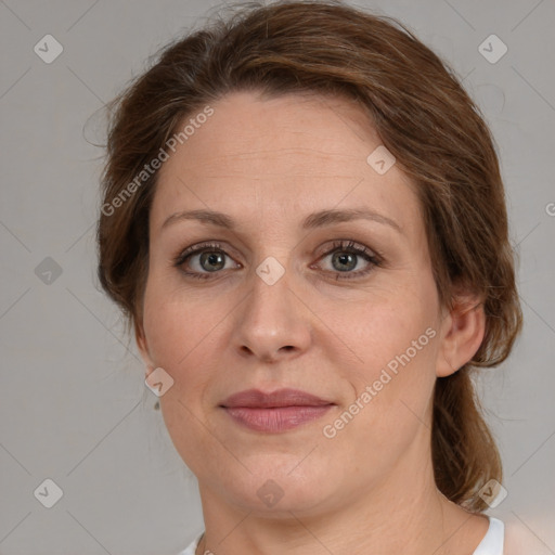 Joyful white adult female with medium  brown hair and green eyes