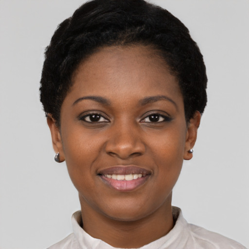 Joyful black young-adult female with short  black hair and brown eyes