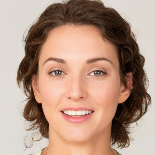 Joyful white young-adult female with medium  brown hair and green eyes