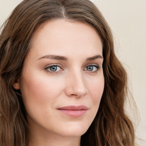 Joyful white young-adult female with long  brown hair and green eyes