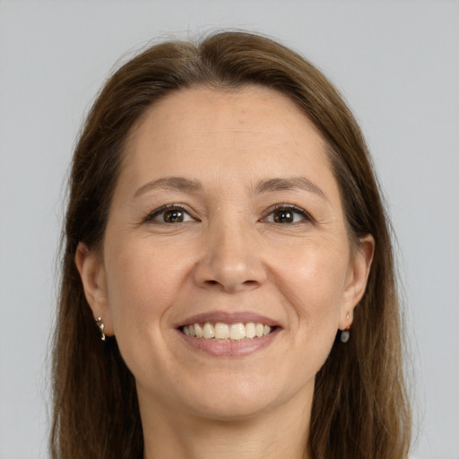 Joyful white adult female with long  brown hair and brown eyes