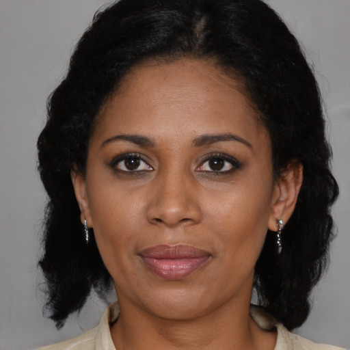 Joyful black adult female with medium  black hair and brown eyes