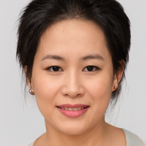 Joyful asian young-adult female with medium  brown hair and brown eyes