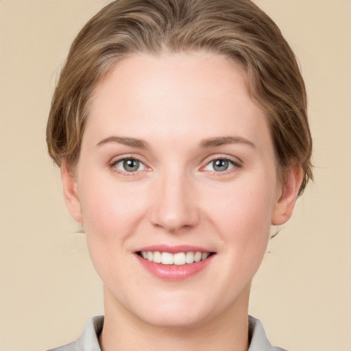 Joyful white young-adult female with short  brown hair and grey eyes