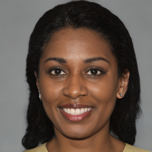Joyful black young-adult female with medium  black hair and brown eyes
