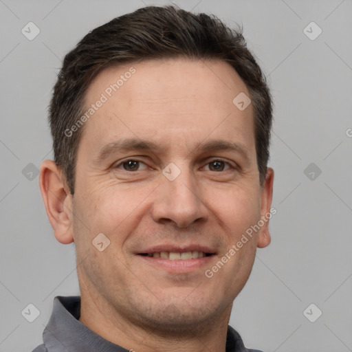 Joyful white adult male with short  brown hair and brown eyes