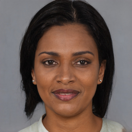 Joyful latino young-adult female with medium  black hair and brown eyes