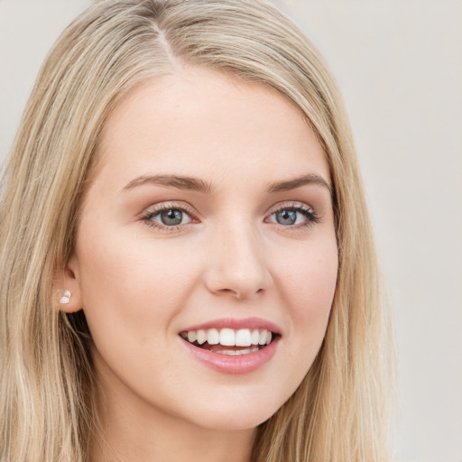 Joyful white young-adult female with long  brown hair and blue eyes