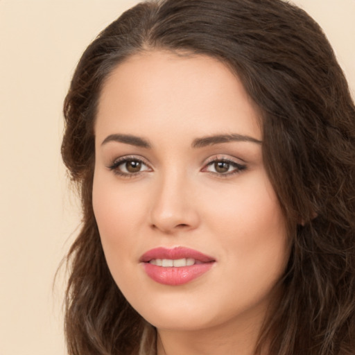 Joyful white young-adult female with long  brown hair and brown eyes