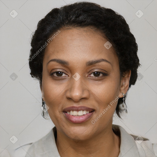 Joyful black adult female with short  black hair and brown eyes