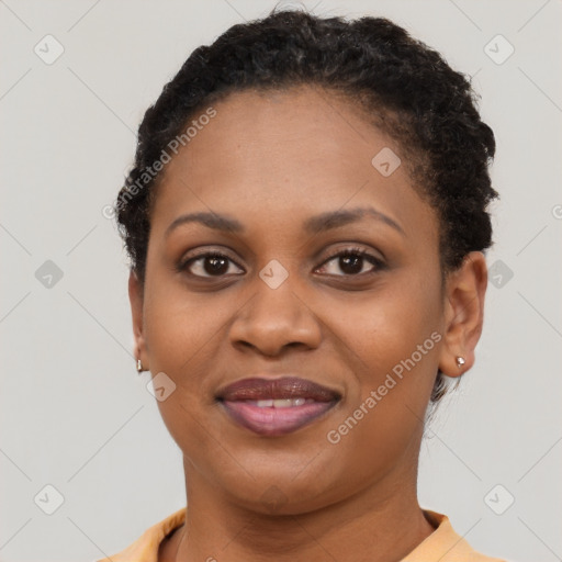 Joyful black young-adult female with short  brown hair and brown eyes