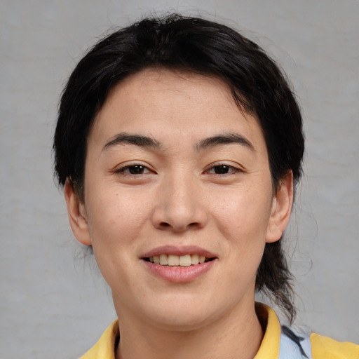 Joyful asian young-adult female with medium  brown hair and brown eyes