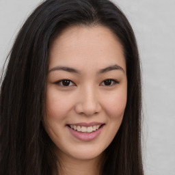 Joyful asian young-adult female with long  brown hair and brown eyes