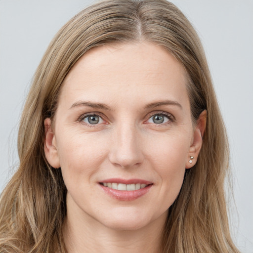 Joyful white young-adult female with long  brown hair and blue eyes