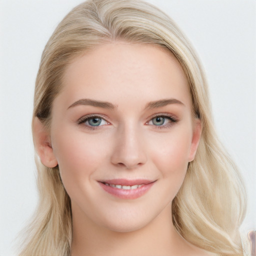 Joyful white young-adult female with long  brown hair and blue eyes