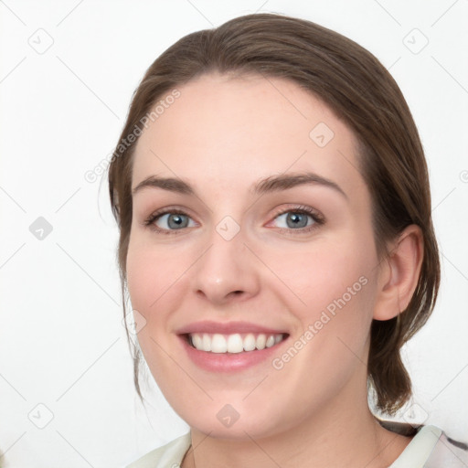 Joyful white young-adult female with medium  brown hair and green eyes