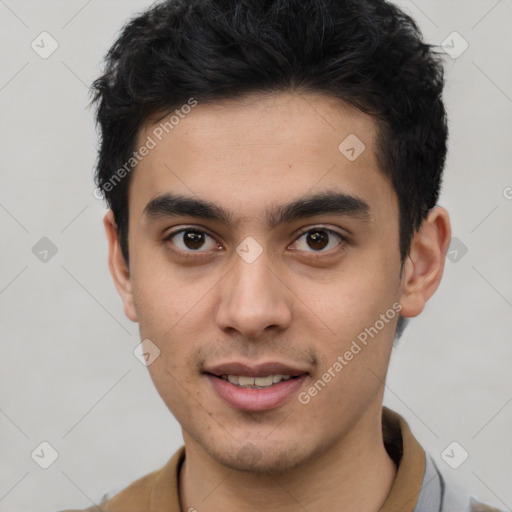 Joyful latino young-adult male with short  brown hair and brown eyes