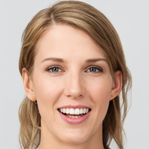 Joyful white young-adult female with medium  brown hair and grey eyes