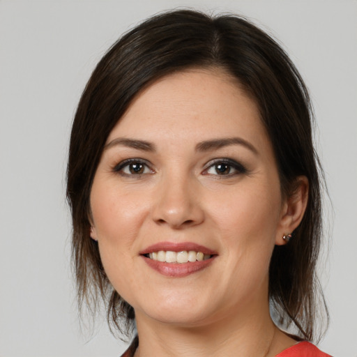 Joyful white young-adult female with medium  brown hair and brown eyes