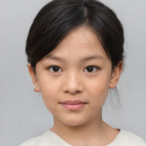 Joyful asian child female with medium  brown hair and brown eyes