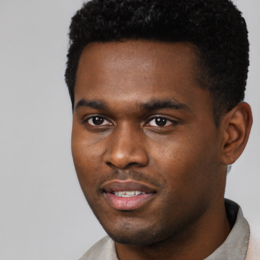 Joyful black young-adult male with short  black hair and brown eyes