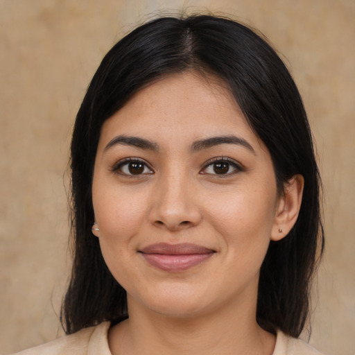 Joyful latino young-adult female with medium  black hair and brown eyes