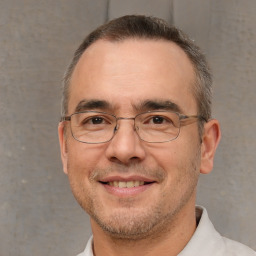 Joyful white adult male with short  brown hair and brown eyes