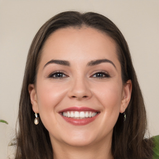 Joyful white young-adult female with long  brown hair and grey eyes