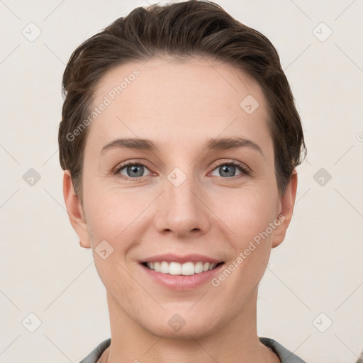 Joyful white young-adult female with short  brown hair and grey eyes