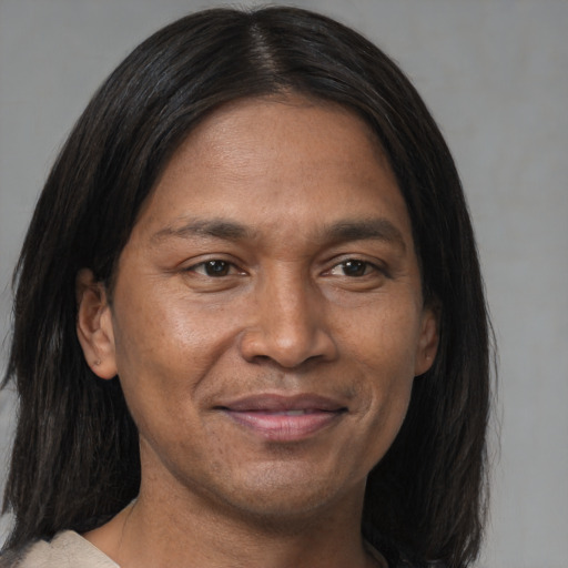 Joyful asian adult male with medium  brown hair and brown eyes