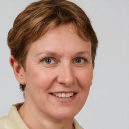 Joyful white adult female with medium  brown hair and grey eyes