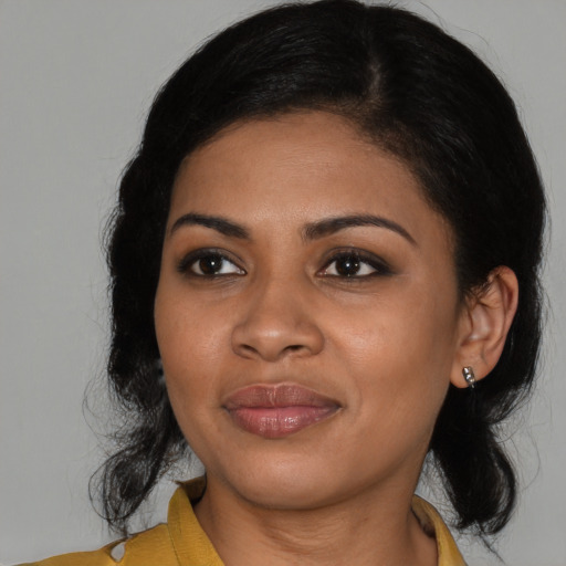 Joyful black young-adult female with medium  black hair and brown eyes