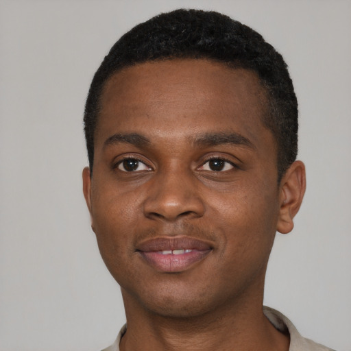 Joyful black young-adult male with short  brown hair and brown eyes