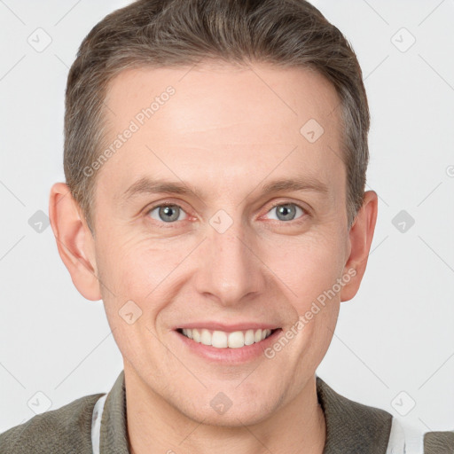 Joyful white adult male with short  brown hair and grey eyes