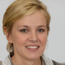 Joyful white young-adult female with medium  brown hair and blue eyes