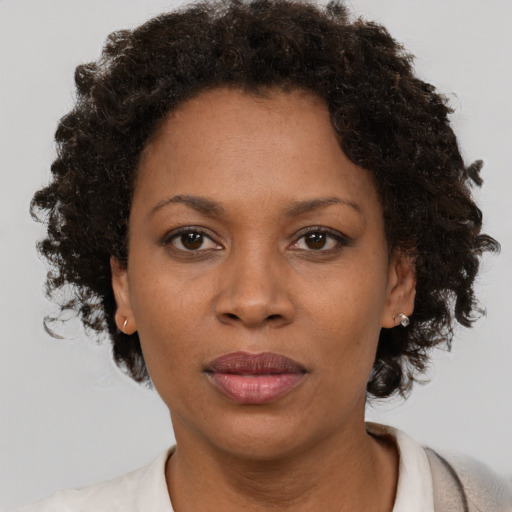 Joyful black adult female with short  brown hair and brown eyes