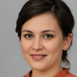 Joyful white young-adult female with medium  brown hair and brown eyes